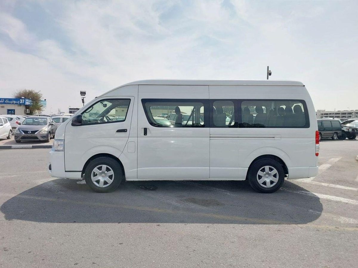 Side view of a Toyota Hiace high roof van used for car lift in Dubai